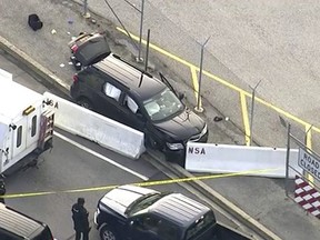 In this image made from video and provided by WUSA TV-9, authorities investigate the scene of a shooting at Fort Meade, Md. on Wednesday, Feb. 14, 2018.  (WUSA TV-9 via AP)