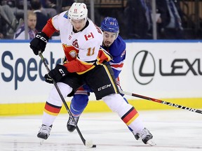 Mikael Backlund of the Calgary Flames fights for the puck against Mika Zibanejad of the New York Rangers at Madison Square Garden on February 9, 2018 in New York. (Abbie Parr/Getty Images)