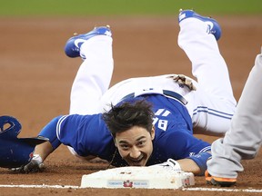 Darwin Barney of the Toronto Blue Jays crawls into third base after stumbling during MLB action against the Baltimore Orioles at Rogers Centre on September 11, 2017 in Toronto. (Tom Szczerbowski/Getty Images)
