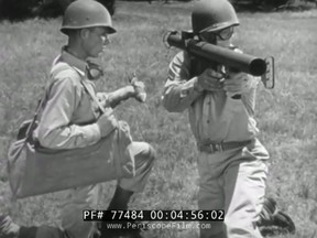 Two soldiers prepare to load the M6 bazooka launcher with a rocket in this video screengrab of a Second World War training film. (VIDEO SCREENSHOT/THE ANTI-TANK ROCKET M6 WWII BAZOOKA TRAINING FILM 77484)