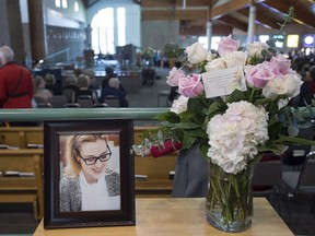 A photograph and a floral arrangement sit in the reception area at the funeral for Rebecca Schofield at Immaculate Heart of Mary Catholic Church in Riverview, N.B. on Wednesday, Feb. 21, 2018.