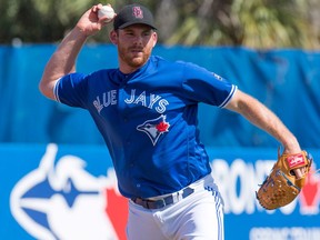 Toronto Blue Jays starting pitcher Joe Biagini throws out Philadelphia Phillies Cameron Rupp at first base during spring training action in Dunedin on Feb. 23, 2018