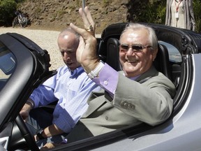 In this June 13, 2011, file photo, Denmark's Prince Henrik, right, waves as he drives a Tesla Roadster at the electric car maker's headquarters in Palo Alto, Calif. (AP Photo/Paul Sakuma, File)