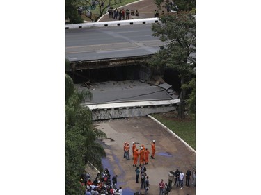 Emergency personnel work on an overpass that collapsed in the centre of Brasilia, Brazil, Tuesday, Feb. 6, 2018.  (AP Photo/Eraldo Peres)