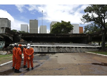 Emergency personnel look at an overpass that collapsed in Brasilia, Brazil, Tuesday, Feb. 6, 2018. (AP Photo/Eraldo Peres)
