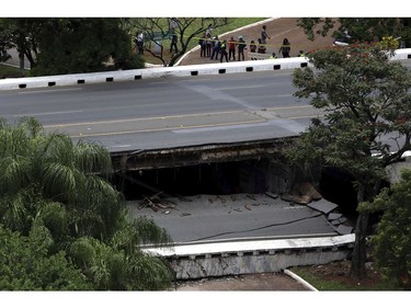 Emergency personnel work on an overpass that collapsed in Brasilia, Brazil, Tuesday, Feb. 6, 2018.  (AP Photo/Eraldo Peres)