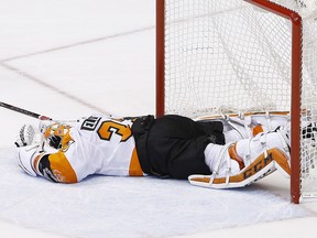 Philadelphia Flyers goaltender Brian Elliott stays on the ice due to injury Saturday, Feb. 10, 2018, in Glendale, Ariz. (AP Photo/Ross D. Franklin)