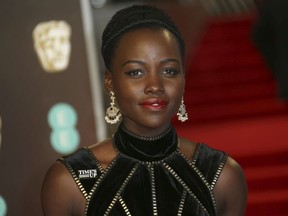 Actress Lupita Nyong'o poses for photographers upon arrival at the BAFTA 2018 Awards in London, Sunday, Feb. 18, 2018.