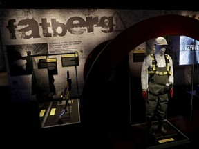 A mannequin displays worker safety clothing and equipment worn to remove a fatberg from sewers in the Whitechapel area of east London in the latter months of 2017, during a media preview at the Museum of London in London, Thursday, Feb. 8, 2018.