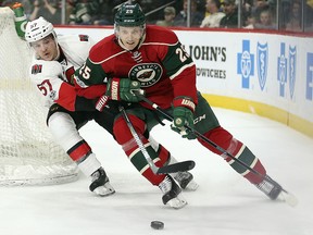 Minnesota Wild's Jonas Brodin (25) controls the puck around the back of the net against Ottawa Senators' Tommy Wingels (57) Thursday, March 30, 2017, in St. Paul, Minn. (AP Photo/Stacy Bengs)