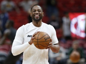 Miami Heat guard Dwyane Wade smiles as he warms up for the team's NBA basketball game against the Milwaukee Bucks, Friday, Feb. 9, 2018, in Miami. Wade was traded back to the Heat from the Cleveland Cavaliers on Thursday.