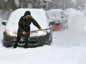 Calgarians dig out after the city recieved a massive dump of snow overnight on Thursday February 8, 2018.