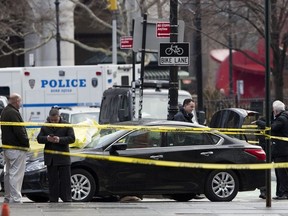 Police investigate a car stopped in front of a security gate, Monday, Feb. 5, 2018, at City Hall in New York.