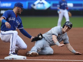 Corey Dickerson of the Tampa Bay Rays is caught stealing as Josh Donaldson of the Toronto Blue Jays tags him out at Rogers Centre on June 13, 2017 in Toronto. (Tom Szczerbowski/Getty Images)