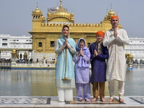 Canadian Prime Minister Justin Trudeau, right, his wife Sophie Gregoire Trudeau, left, their daughter Ella Grace, second left, and son Xavier greet in Indian style during their visit to Golden Temple, in Amritsar, India, Wednesday, Feb. 21, 2018.