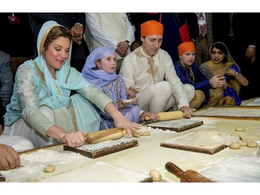 Canadian Prime Minister Justin Trudeau, third left, and his wife Sophie Gregoire Trudeau, left, make Rotis or Indian flat bread during their visit to Golden Temple, in Amritsar, India, Wednesday, Feb. 21, 2018.