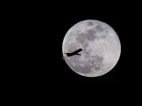 A airplane flying over Norfolk, Va., is silhouetted by the full moon on Wednesday, Jan. 31, 2018. A national pilots associaiton is raising alarm bells over new accident numbers showing a year-over-year jump in incidents involving commercial airliners.