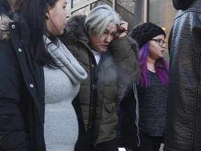 Thelma Favel, centre, Tina Fontaine's great-aunt and the woman who raised her, weeps as she enters the law courts in Winnipeg with family and supporters the day the jury delivered a not-guilty verdict in the 2nd degree murder trial of Raymond Cormier, Thursday, February 22, 2018. THE CANADIAN PRESS/John Woods ORG XMIT: JGW111