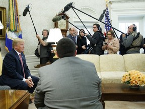 President Donald Trump speaks to reporters in the Oval Office of the White House, Friday, Feb. 9, 2018, in Washington.