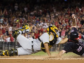 Elias Diaz of the Pittsburgh Pirates tags out Daniel Murphy of the Washington Nationals at home plate at Nationals Park on September 29, 2017 in Washington, DC. (Patrick McDermott/Getty Images)