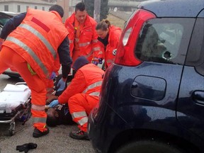 Italian Paramedics a wounded man after a shooting broke out in Macerata, Italy, Saturday, Feb. 3, 2018. (Guido Picchio/ANSA via AP)
