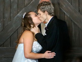 In this Sunday, Jan. 28, 2018, file photo, Dustin Snyder, 19, kisses his wife Sierra after exchanging wedding vows at the The Big Red Barn in Plant City, Fla. (Octavio Jones/Tampa Bay Times via AP, File)