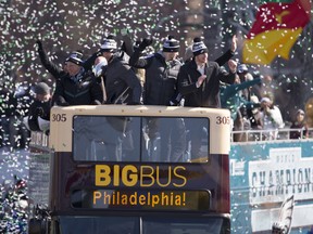Philadelphia Eagles owner Jeffrey Lurie, Nick Foles, Nate Sudfeld, and Carson Wentz ride the bus during the Super Bowl LII parade on Feb. 8, 2018