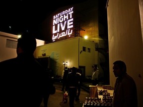 In this Tuesday, Feb. 16, 2016 file photo, people wait for this first "Saturday Night Live Arabia," show to start in Cairo, Egypt.
