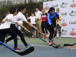 Prime Minister Justin Trudeau, wife, Sophie Gregoire Trudeau and son Xavier take part in a hockey event with Hayley Wickenheiser and the Indian women's national ice hockey team at the Canadian High Commission of Canada in New Delhi, India on Saturday, Feb. 24, 2018.