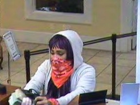 This security camera image released by the FBI shows a 25-year-old woman dubbed the "Freedom Fighter Bandit" robbing a bank in Dallas, Ga., Thursday Jan. 25, 2018.