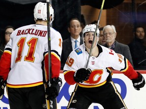 Calgary Flames left-winger Matthew Tkachuk (No. 19) reacts with Mikael Backlund as they celebrate scoring the game-winning goal during the third period of an NHL hockey game against the New York Islanders in New York, Sunday, Feb. 11, 2018. The Flames defeated the Islanders 3-2 in regulation.