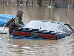 Amber Hawkins checks out a car parked in the rear of a downtown Chatham, Ont., home along the Thames River on Friday, February 23, 2018. (DAN JANISSE/The Windsor Star)