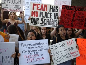 People join together after a school shooting that killed 17 to protest against guns on the steps of the Broward County Federal courthouse on Saturday, Feb. 17, 2018 in Fort Lauderdale, Fla.