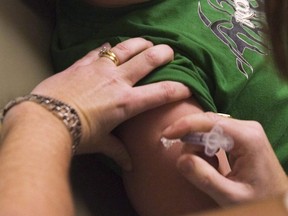 A child receives a seasonal flu shot at a health clinic in Elmsdale, N.S. on Tuesday, Oct. 27, 2009. (THE CANADIAN PRESS/Andrew Vaughan)