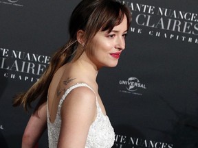 Dakota Johnson poses during a photocall for the world premiere of 'Fifty Shades Freed - 50 Nuances Plus Claires' at Salle Pleyel in Paris, Tuesday, Feb. 6, 2018.