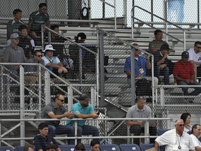 Major League Baseball scouts watch as free agent take part in a scrimmage game Tuesday, Feb. 27, 2018, in Bradenton, Fla.