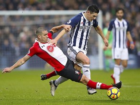 Southampton's Wesley Hoedt, left, and West Bromwich Albion's Gareth Barry in action during their English Premier League match at The Hawthorns in West Bromwich, England, Saturday Feb. 3, 2018. (Nick Potts/PA via AP)