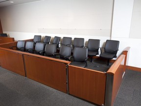 In this stock photo, a jury box sits empty in a courtroom.
