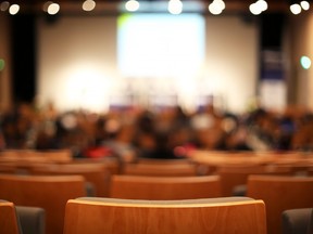 In this stock photo, students sit in a university lecture hall.