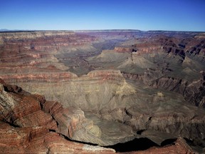 In this Oct. 5, 2013, file photo, the Grand Canyon National Park is covered in the morning sunlight as seen from a helicopter near Tusayan, Ariz.