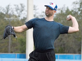 Toronto Blue pitcher J. A. Happ throws long toss prior to the official start of spring training in Dunedin on Feb. 12, 2018