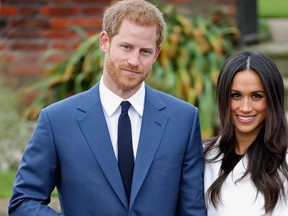 Prince Harry and Meghan Markle during an official photocall to announce their engagement at The Sunken Gardens at Kensington Palace on November 27, 2017 in London, England. (Chris Jackson/Getty Images)