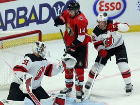 Senators winger Alex Burrows and Devils defenceman Sami Vatanen react as the puck comes off the post behind goaltender Keith Kinkaid during the third period of Tuesday's game.THE CANADIAN PRESS/Fred Chartrand