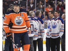 Edmonton Oilers winger Milan Lucic (27) skates past Wayne Gretzky and other former Oilers players as they were introduced as the greatest team of all time in Edmonton on Monday, Feb. 12, 2018.