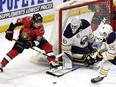 Ottawa Senators' Matt Duchene (95) tires to wrap the puck around the net of Buffalo Sabres goaltender Robin Lehner (40) as Rasmus Ristolainen (55) defends, during first period NHL hockey action in Ottawa, Thursday, February 15, 2018.