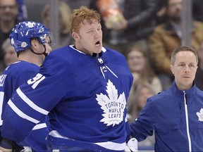 Toronto Maple Leafs goaltender Frederik Andersen (31) is helped off the ice as he leaves the game after being hit during second period NHL hockey action against the Anaheim Ducks in Toronto on Monday, Feb. 5, 2018.