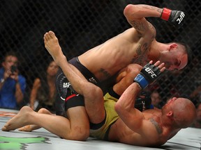 Max Holloway (top) battles Jose Aldo of Brazil during UFC 218 at Little Caesars Arena on December 2, 2018 in Detroit. (Gregory Shamus/Getty Images)