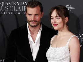 Jamie Dornan, left, and Dakota Johnson pose during a photocall for the world premiere of 'Fifty Shades Freed' in Paris, Tuesday, Feb. 6, 2018.