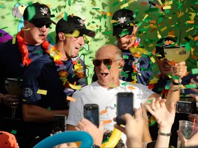 Jimmy Buffett, centre, stands with members of the Wounded Warrior Amputee Softball Team as he toasts the crowd during the grand opening celebration for the Margaritaville Casino at Flamingo Las Vegas October 14, 2011 in Las Vegas, Nevada. (Ethan Miller/Getty Images for Flamingo Las Vegas)