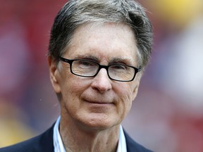 This is a May 11, 2013 file photo showing Boston Red Sox owner John Henry standing on the field before a game against the Toronto Blue Jays in Boston. (AP Photo/Michael Dwyer, File)